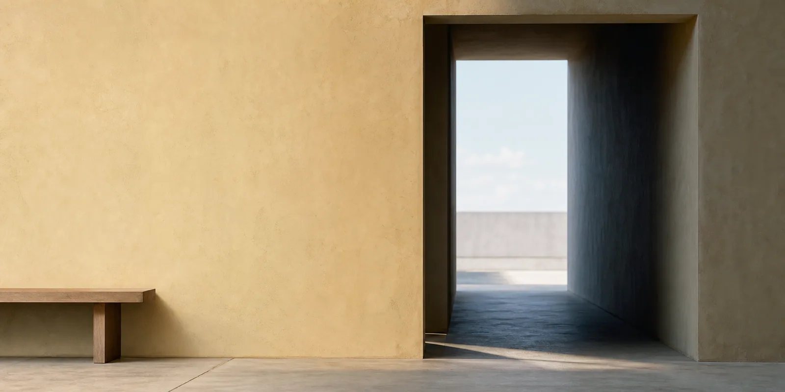Light crosses a quiet architectural threshold with no identifying features